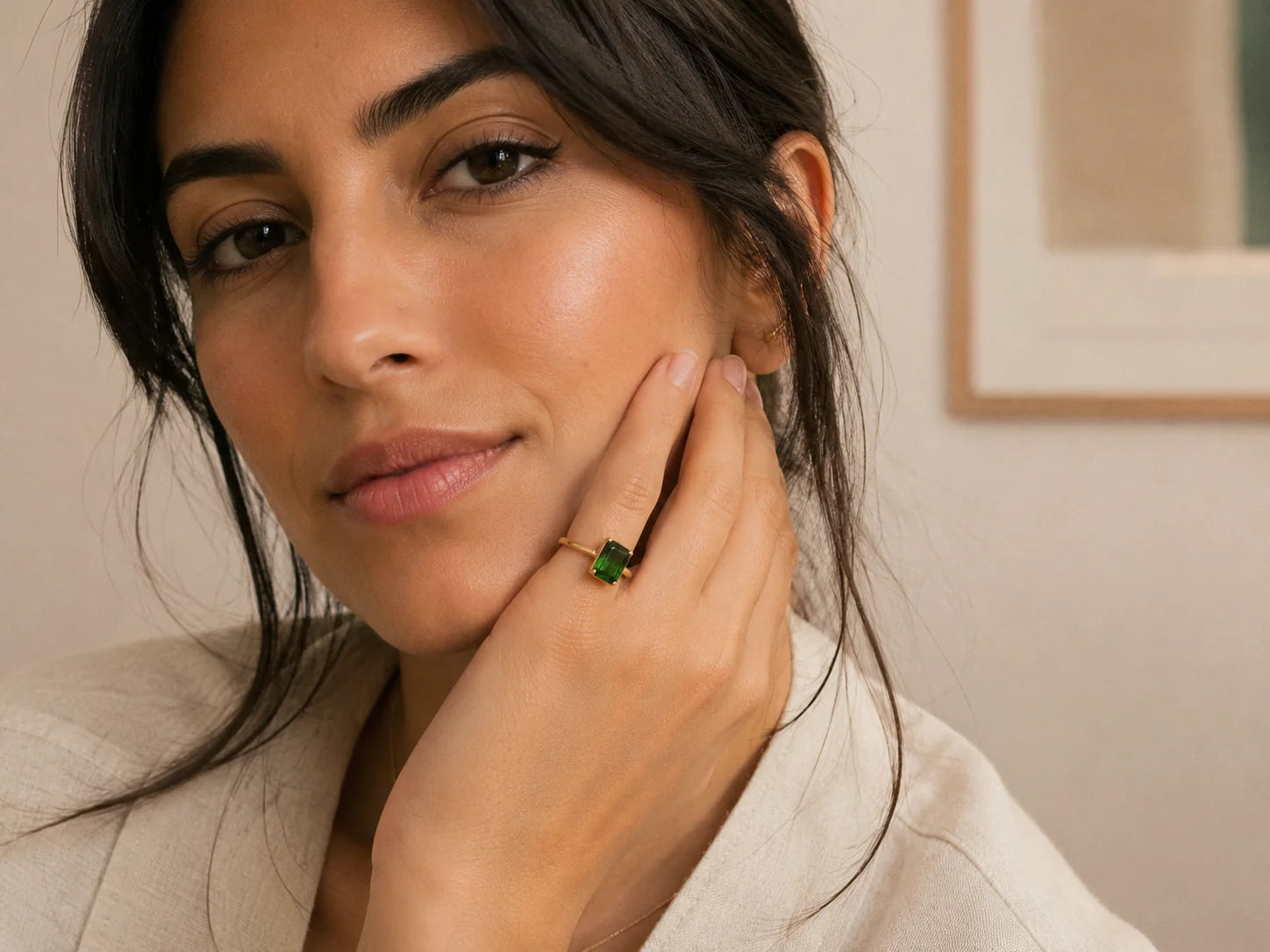 Customer-style photo wearing a green emerald-cut ring