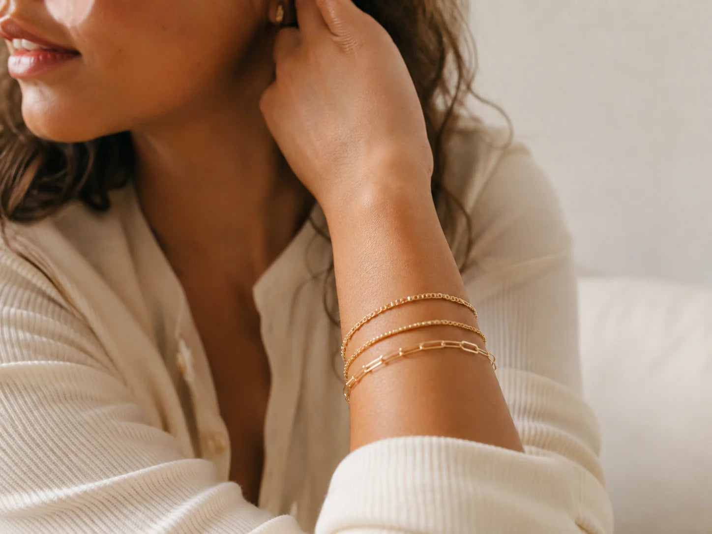 Customer-style photo wearing a gold bracelet stack
