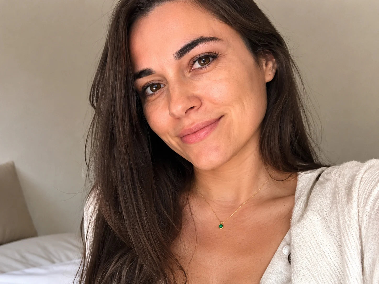 Customer-style selfie wearing a small green pendant necklace